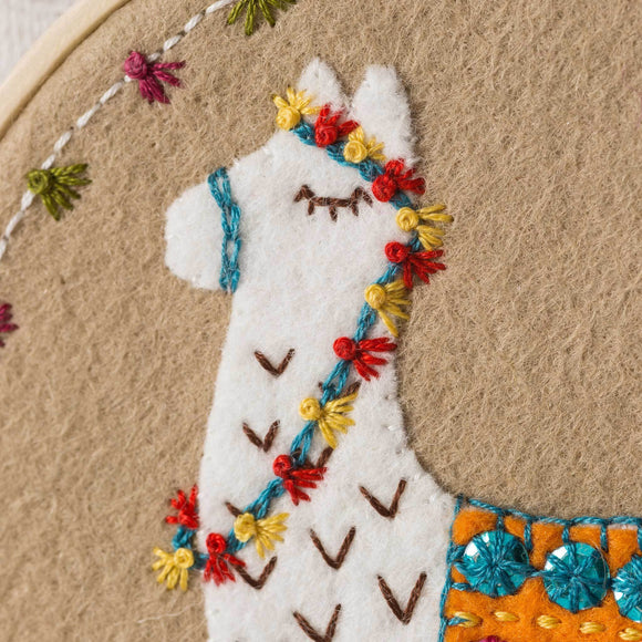 Corinne Lapierre applique hoop felt Llama craft kit. White felt Llama set in a wooden embroidery hoop.