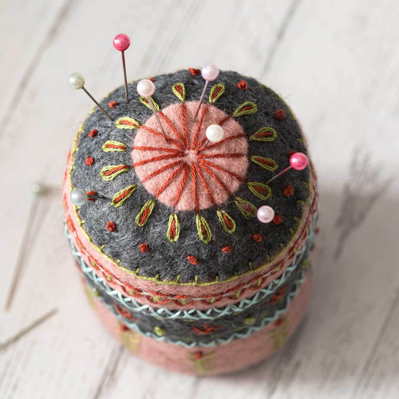 Corinne Lapierre Felt Pin Cushion Embroidery Craft Kit. Round tubular embroidered pin cushion in grey and pink felt.