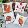 Four Woodland Lavender Bags embroidered on linen. Four animal images. Hedgehog. Red Squirrel. Owl. Toadstools.