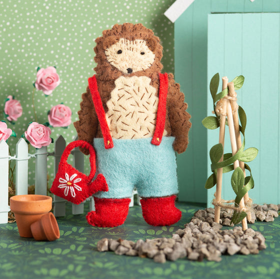Corinne Lapierre Felt Craft Mini Kit. A folk animal hedgehog stands holding a red watering can.