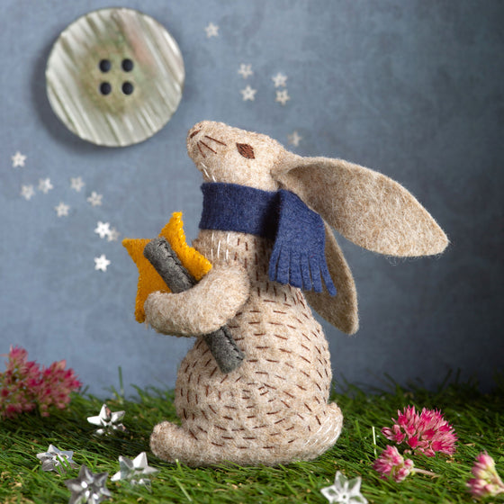 Corinne Lapierre Felt Craft Mini Kit. A felt hare, wearing a blue scarf, gazes up at the stars, holding a star and telescope.
