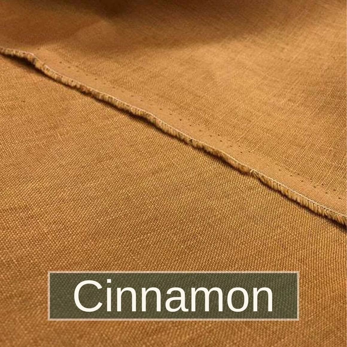 A basket of linen squares and flowers. Cotton thread reels and scissors are in the back ground.