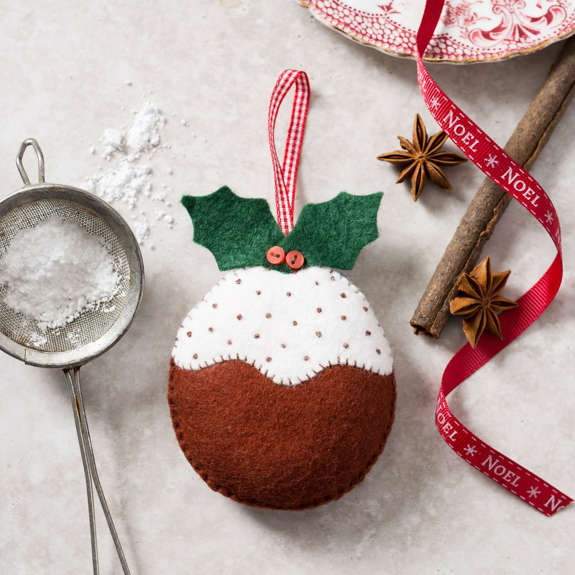 Corinne Lapierre Christmas Pudding Felt Craft Kit. Hung with red & white gingham ribbon.