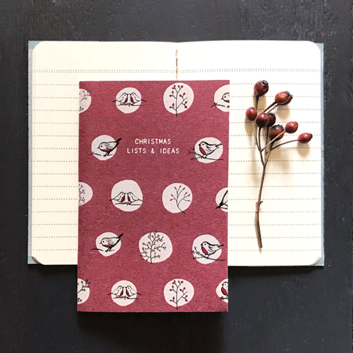 East of India A6 Notebook. Christmas Lists & Ideas. Red background with repeat white circle motifs. with robins.