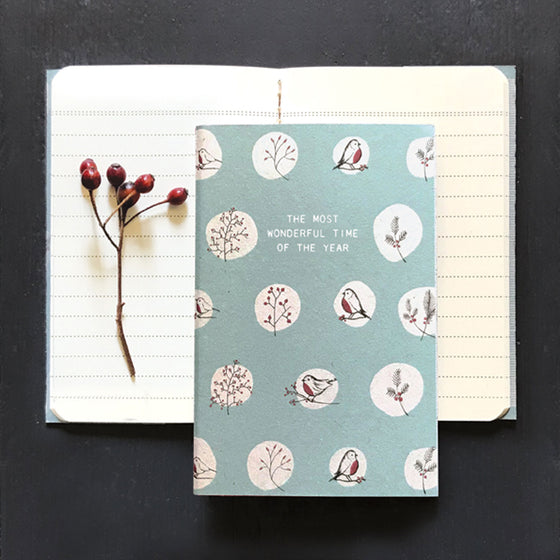  East of India A6 Notebook. Light blue background with repeat pattern, of white circles with bird. & berries motifs.